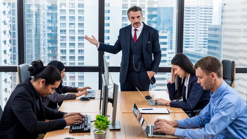 Angry boss complaining team about mistake in workplace.